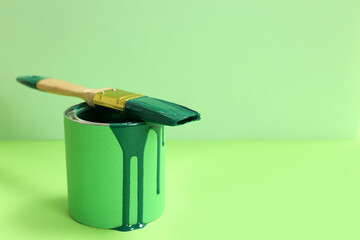 Poster - Can of green paint with brush on color background. Space for text