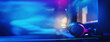 © Parilov - Professional headphones with microphone for video games and cyber sports on banner background blue dark light