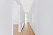 Bright white walls and interior details of long corridor in modern house
