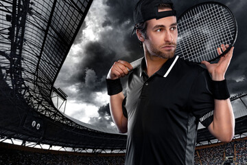 Wall Mural - Tennis player with racket in black t-shirt. Man athlete playing isolated on dark background.