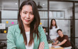 © Ann Rodchua - Beautiful smart Asian business woman wearing casual clothes, smiling with confidence, crossing arms, with blur background of colleagues, working with positivity, looking camera, standing in office.