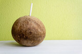 Fototapeta Natura - Coconut water with straw with copy space