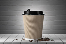 White Paper Cup On A Wooden Table, Kraft-colored Rimmed Cardboard, Red Brick Wall On The Background. 3d Render.