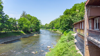 Poster - The Olza between Cesky Tesin in Czech Republic and Cieszyn in Poland in summer time.