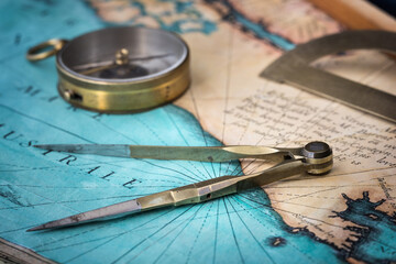 Poster - An old geographic map with navigational tools: compass, divider, ruler, protractor. View of the workplace of ship's captain. Travel, geography, navigation, tourism and exploration concept background.