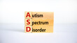 ASD, autism spectrum disorder symbol. Wooden blocks with words 'ASD, autism spectrum disorder'. Beautiful white background. Medical and ASD, autism spectrum disorder concept. Copy space.