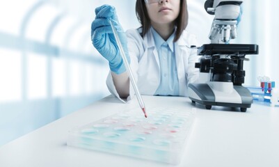 Wall Mural - medical research laboratory, female scientist using micro pipette for test analysis.