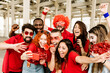 © Xavier Lorenzo - Group of multiracial supporter sport fans taking selfie with mobile phone while supporting their football team - Young people having fun outside the stadium after sport event