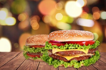 Sticker - Tasty grilled homemade burgers with beef, tomato, cheese on rustic wooden background.