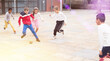 © JackF - Cheerful tween schoolchildren gaily spending time together on warm spring day, playing with ball near school building.