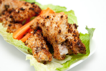 Canvas Print - Closeup shot of an oven-roasted barbeque with carrots on a white background