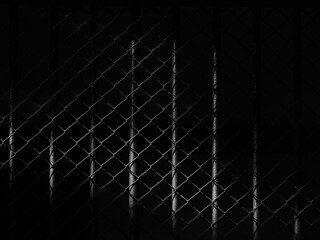 wire mesh of cage with light and shadow, black and white style
