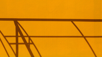 Canvas Print - shadow structure of roof on yellow wall background