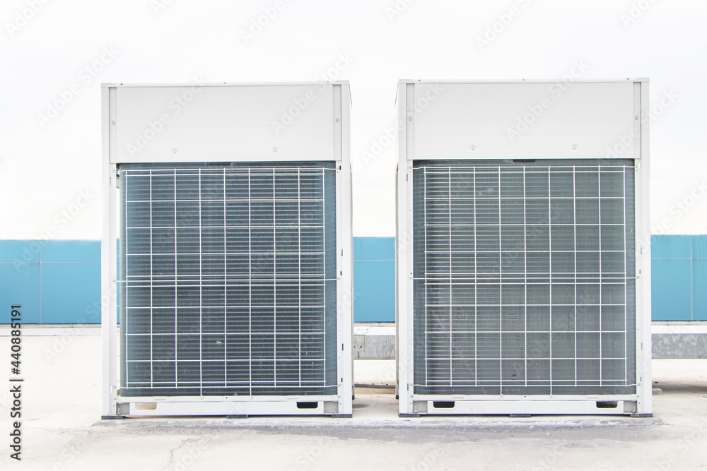 Two Big air conditioner compressor source heat pumps on the wall ...