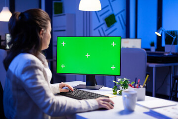 Poster - businesswoman looking at green screen monitor of computer sitting at desk during online web conferen