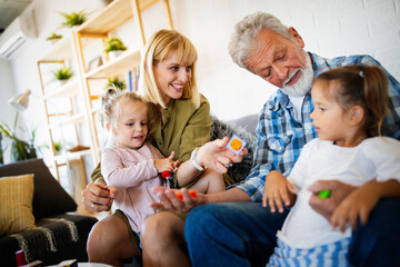 Wall Mural - Senior grandparents playing with grandchildren and having fun with family