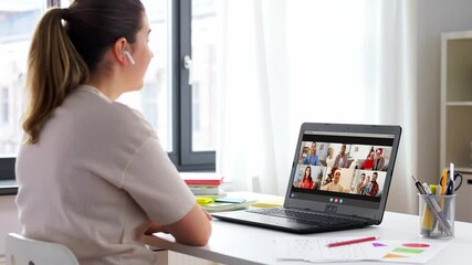 Poster - communication, technology and people concept - happy smiling woman in earphones with laptop computer having video call with family on christmas at home