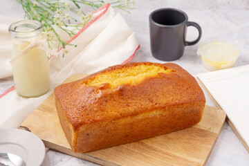 Wall Mural - Pound cake with lemon glaze on cutting board, milk in glass bottle.