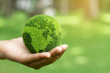 Close up hands holding earth on green background.protect nature.Save Earth.concept of the environment World Earth Day
