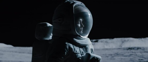 cu portrait of caucasian female lunar astronaut opens her visor while exploring moon surface. shot w