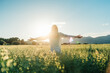 © ADDICTIVE STOCK - Happy woman showing V sing in countryside field