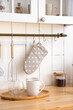 Kitchen utensils and dishes on the wall potholder with polka dots, whisk