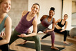 © Drazen - Group of happy athletic women doing stretching exercises on Pilates class at health club.
