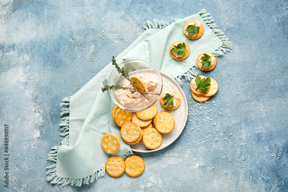 Composition with tasty crackers and sauce on color background