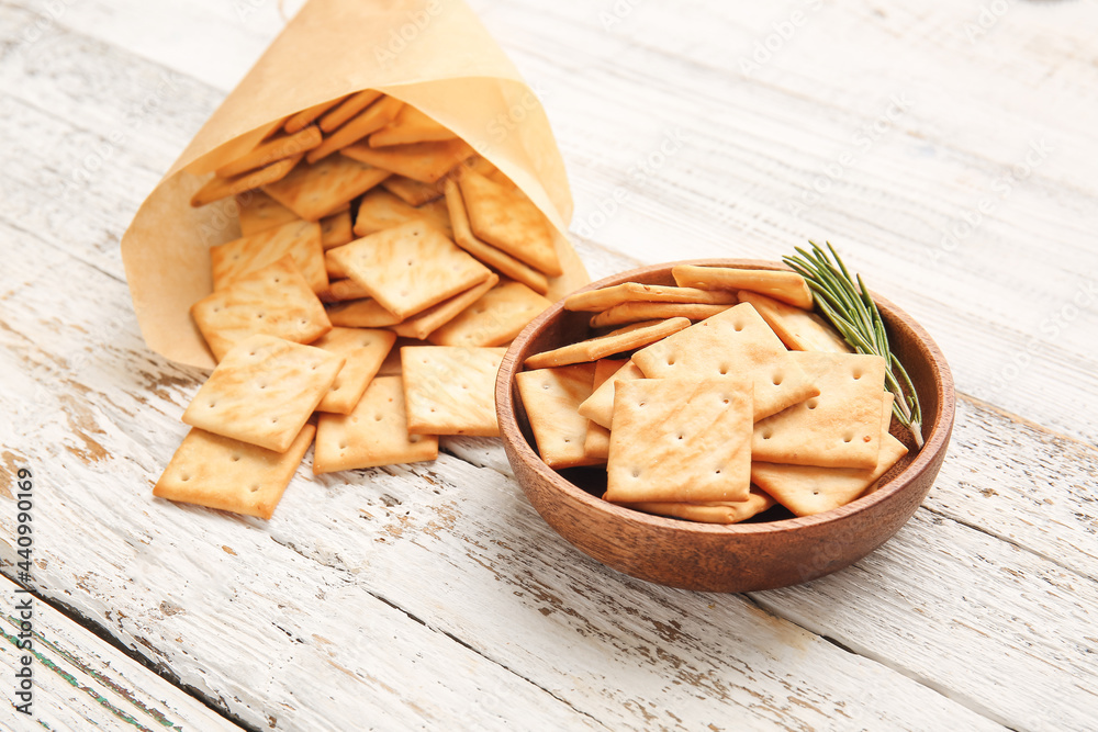 Composition with tasty crackers on light wooden background