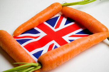 Four carrots surrounding a Union Jack Flag, isolated on a white background