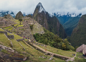 Wall Mural - Panoramic view of Machu Picchu lost city with Huayna Picchu mountain. Ruins of ancient inca civilization in the sacred valley of Cusco Province. Peru, South America