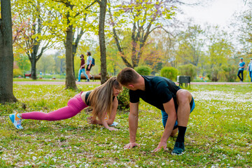 Fit couple stretching in the park on a sunny day