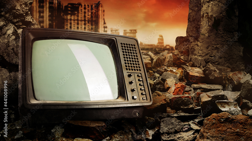 Photo of old fashioned tv set laying on pile of bricks on ruined city wasteland background. - obrazy, fototapety, plakaty 