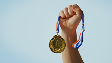 Wall Mural - woman hand raised, holding gold medal against sky. award and victory concept