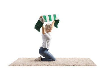 Wall Mural - Young female kneeling on a carpet and waving a scarf