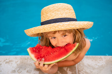 Child with watermelon in swimming pool. Kids eat summer fruit outdoors. Healthy children.