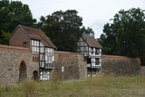 Fototapeta  - Side view of historic Wiek houses in the town of Neubrandenburg, Germany on a gloomy day