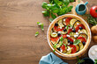 Vegetable tart with zucchini, aubergine, tomato, olives and feta cheese, top view
