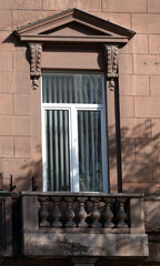 Facade of an old building with a balcony