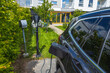 Close up view of parked vehicle connected to charging station. Sweden.