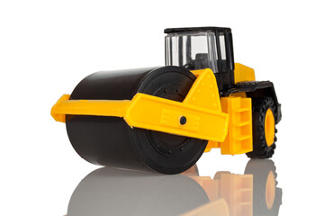 Children's toy road construction roller, vibroroller, asphalt paver, isolated on a white background, close-up