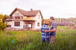 © Smole - rear view of young couple looking at their new house
