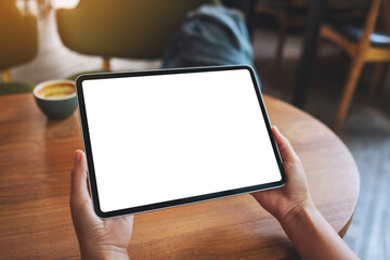 Mockup image of a woman holding digital tablet with blank white desktop screen