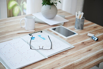 Wall Mural - Opened folder with sales reports and glasses on table of entrepreneur