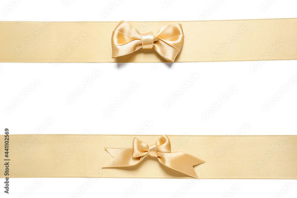Beautiful golden ribbons with bows on white background