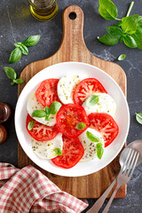 Canvas Print - Caprese Salad with fresh tomatoes, basil and mozzarella cheese, top view