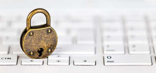 Internet security, password change banner, padlock on a white computer laptop keyboard