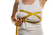 © vladimirfloyd - a woman measures with a measuring tape her large breasts
