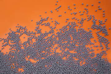 Grey polymer compound on orange background