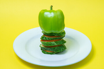 Sticker - Sliced vegetables in a plate on a yellow background. Healthy diet food made from fresh vegetables. Vegetarian food